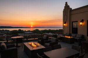 Beacon Lounge rooftop bar at Park Place Hotel Traverse City with sunset view over Grand Traverse Bay.