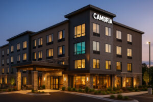 Cambria Hotel Traverse City exterior at dusk with warm lighting and modern boutique design