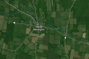 Clear summer sky over village streets showing north bennington vt weather on a bright afternoon