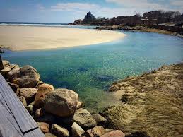 Shallow, calm waters and wide sandy shores along Lake Michigan’s tranquil Good Harbor Bay