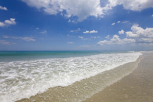 Lesser-known Gulf Shores beaches: pristine shores edged with sea oats, driftwood, and calm waves, accessible via trails through coastal wetlands or historic fort landscapes