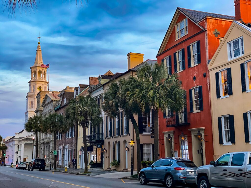 A scenic view of historic Charleston SC, featuring cobblestone streets, historic homes, and the iconic church steeples.