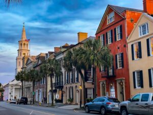 A scenic view of historic Charleston SC, featuring cobblestone streets, historic homes, and the iconic church steeples.