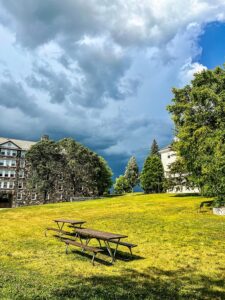 A scenic New England college town nestled in the Green Mountains, featuring Middlebury College’s stone chapel, a cascading waterfall on Otter Creek, and a historic downtown lined with red-brick buildings and a covered bridge.