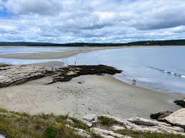 Peaceful coastal landscape at Reid State Park in Georgetown, featuring sandy dunes and calm waters.