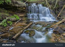 A gentle 25-foot waterfall framed by hemlock trees, with an accessible boardwalk leading to its crystal-clear pool in Michigan’s Hiawatha National Forest