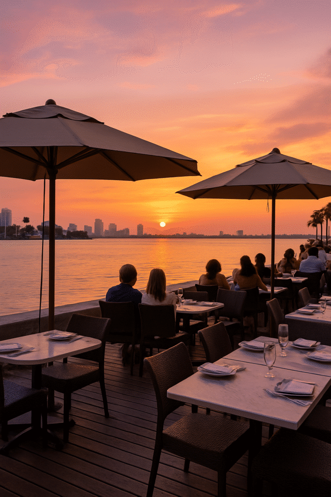 Sunset diners enjoying a peaceful meal by the water with skyline views—capturing the best time to hit these waterfront spots (and when to avoid them).